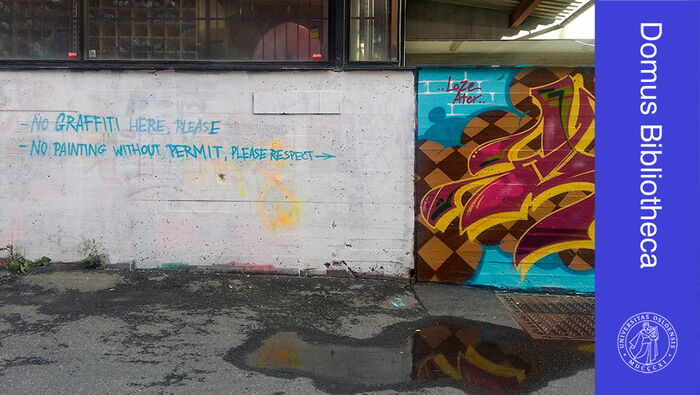 Bilde av vegg med grafitti til høyre og et tomt felt det det står "No graffiti here please" til venstre