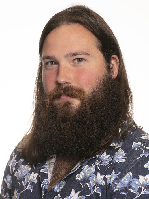 A photo of a man with long hair and beard.