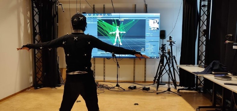 Person rigged with motion capture equipment